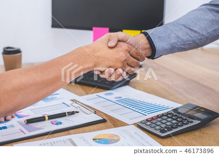 Finishing up a meeting, Business handshake after discussing good Finishing up a meeting, Business handshake after discussing good 46173896