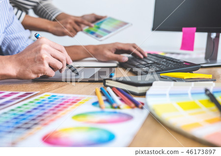 Two colleagues creative graphic designer working on color select Two colleagues creative graphic designer working on color select 46173897