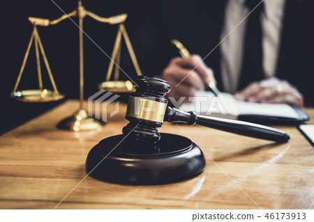 Male lawyer or judge working with contract papers, Law books and 46173913