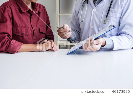 Doctor consulting patient discussing something and recommend tre Doctor consulting patient discussing something and recommend tre 46173930
