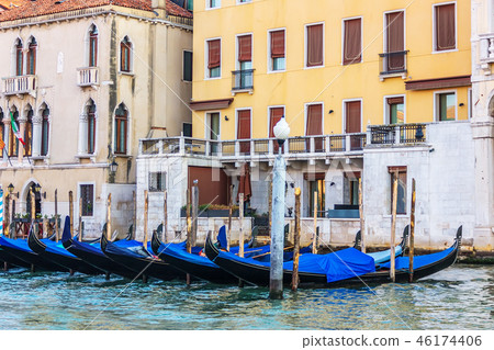 Gondolas moored in front of the terrace of a venetian palace on Gondolas moored in front of the terrace of a venetian palace on 46174406