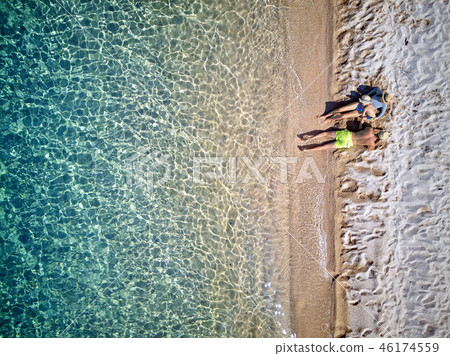 Beautiful beach with family drone shot Beautiful beach with family drone shot 46174559
