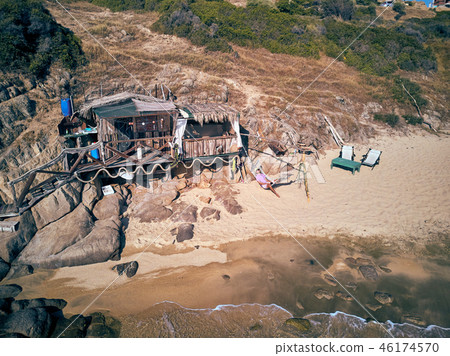 Man in hammock on a beach aerial view Man in hammock on a beach aerial view 46174570