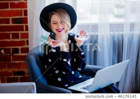 Young girl with laptop computer and credit card Young girl with laptop computer and credit card 46176145