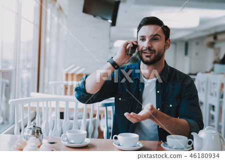 Man is Talking on Mobile Phone in Cafe Man is Talking on Mobile Phone in Cafe 46180934
