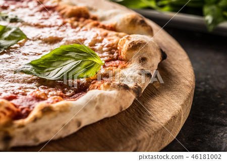 Italian traditional pizza margarita on round board Italian traditional pizza margarita on round board 46181002