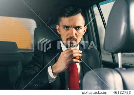 Young depressed businessman sitting in the car. Young depressed businessman sitting in the car. 46182728