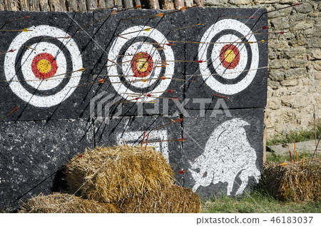 three targets with arrows in the yard outdoors 46183037