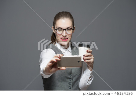 Charming positive office woman makes selfie on smartphone Charming positive office woman makes selfie on smartphone 46184186