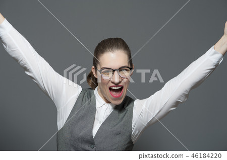 Cheerful businesswoman standing hands to the sky Cheerful businesswoman standing hands to the sky 46184220