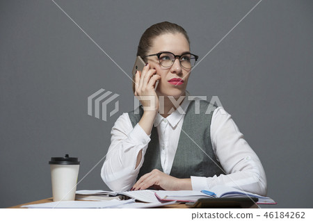 Pretty businesswoman pouting making a call Pretty businesswoman pouting making a call 46184262
