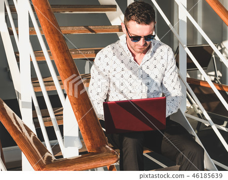 Stylish, attractive man with laptop Stylish, attractive man with laptop 46185639
