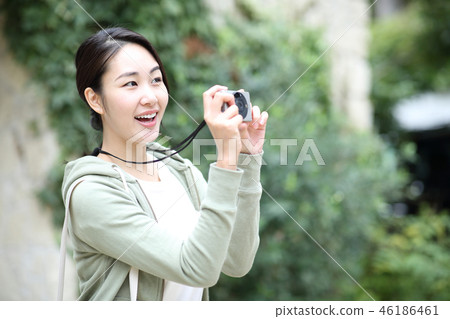 A woman taking a picture A woman taking a picture 46186461