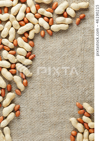 Roasted peanuts in a shell and peeled on a brown  46190215