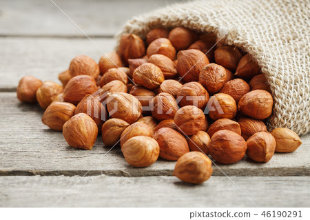 Chiselled hazelnuts in a bag of burlap on a gray  46190291