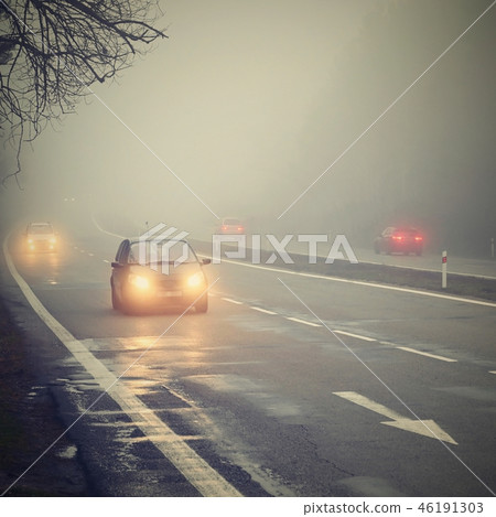 Bad weather driving - foggy hazy country road.  46191303