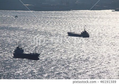 Shadow of a transport ship across the sea 46191389