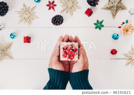Top view of hand holding christmas gift Top view of hand holding christmas gift 46191621