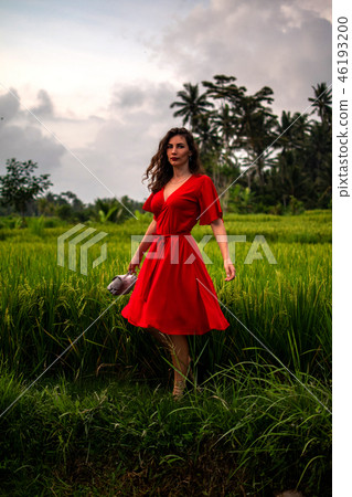 Fashionable model holding leather snakeskin python bag, Elegant outfit. Model in jungle. Concept in 46193200
