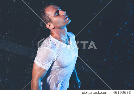 Fresh portrait of muscular man with water splashes on dark background. Fresh portrait of muscular man with water splashes on dark background. 46193688