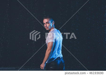Fresh portrait of muscular man with water splashes on dark background. Fresh portrait of muscular man with water splashes on dark background. 46193690