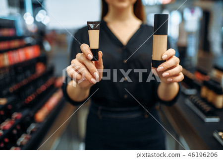 Female seller shows cosmetics in the makeup shop Female seller shows cosmetics in the makeup shop 46196206