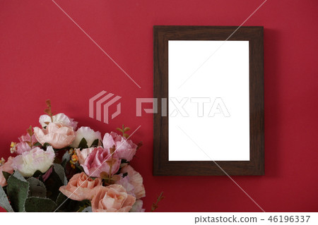 empty photo frame on red background and flowers 46196337