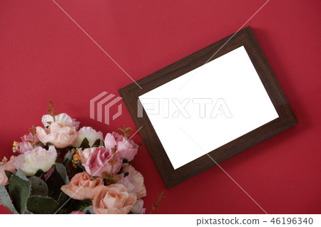 empty photo frame on red background and flowers 46196340