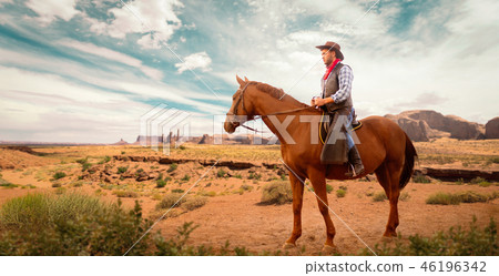 Cowboy in leather clothes riding a horse, western 46196342