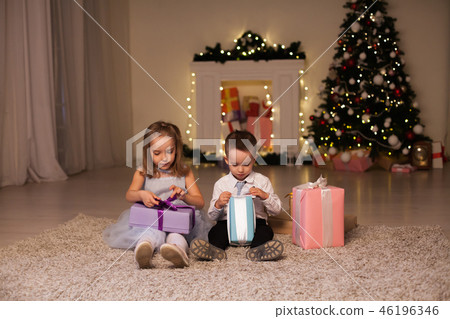 little boy and girl open Christmas presents new year winter Christmas tree 46196346