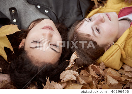 Pretty woman and teen girl are in autumn park 46196496