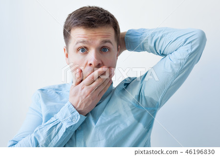 man is worried and shows sweating stain problem 46196830