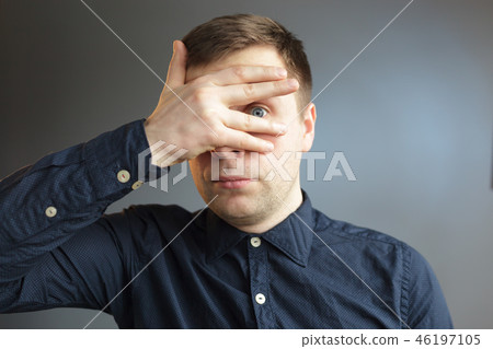 man in tin foil hat fearfully pulls palms forward man in tin foil hat fearfully pulls palms forward 46197105