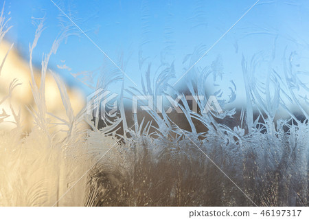 Frozen winter window with shiny ice frost pattern texture Frozen winter window with shiny ice frost pattern texture 46197317