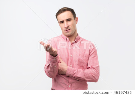 Sad unhappy young man in pink shirt Sad unhappy young man in pink shirt 46197485