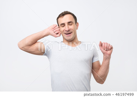Young italian man yawing and stretching 46197499