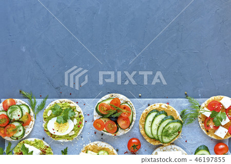 Border of savory appetizers or canapes 46197855