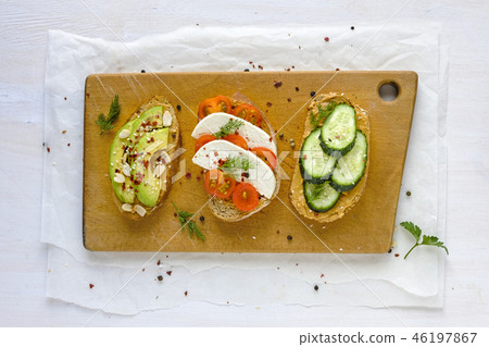Set of sandwiches served on wooden board 46197867