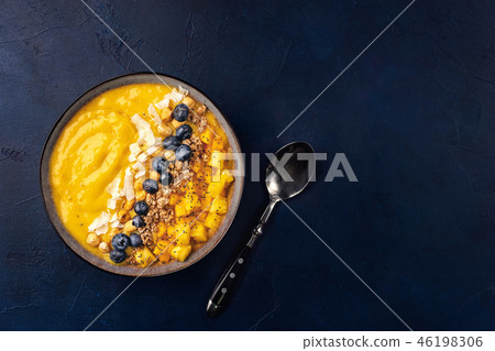 Top view of mango smoothie bowl with fruits 46198306