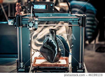 3D printer printing a model in the form of black vase close-up. 3D printer printing a model in the form of black vase close-up. 46199119
