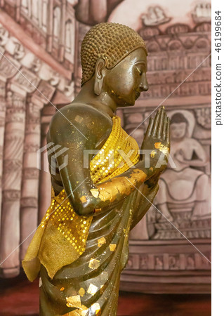 Golden standing Buddha statue. Golden standing Buddha statue. 46199684