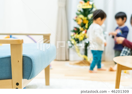 Parents and children decorating a Christmas tree 46201309