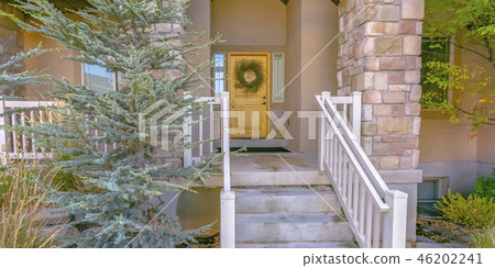 Home with stairs leading to porch and front door 46202241
