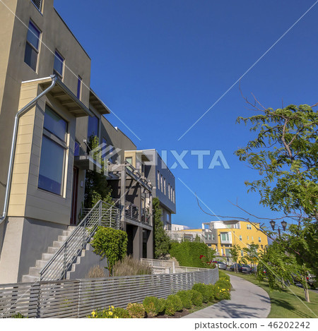 Home with stairs and flat roof against blue sky Home with stairs and flat roof against blue sky 46202242