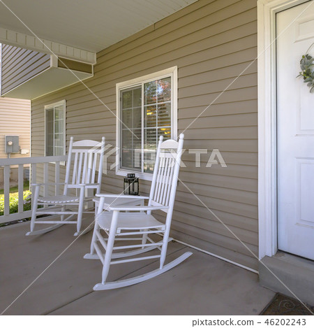 Home with rocking chairs and table on the porch 46202243