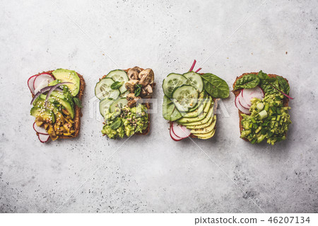 Avocado toasts with different toppings, top view 46207134