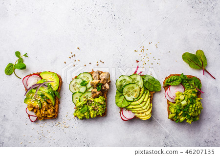 Avocado toasts with different toppings, top view 46207135