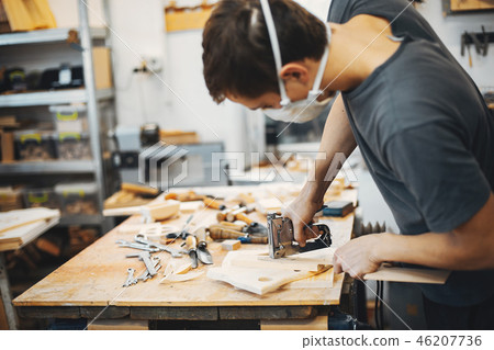 The carpenter works with a tree The carpenter works with a tree 46207736