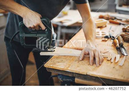 The carpenter works with a tree 46207752