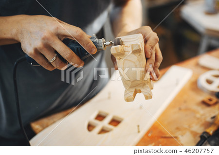 The carpenter works with a tree 46207757